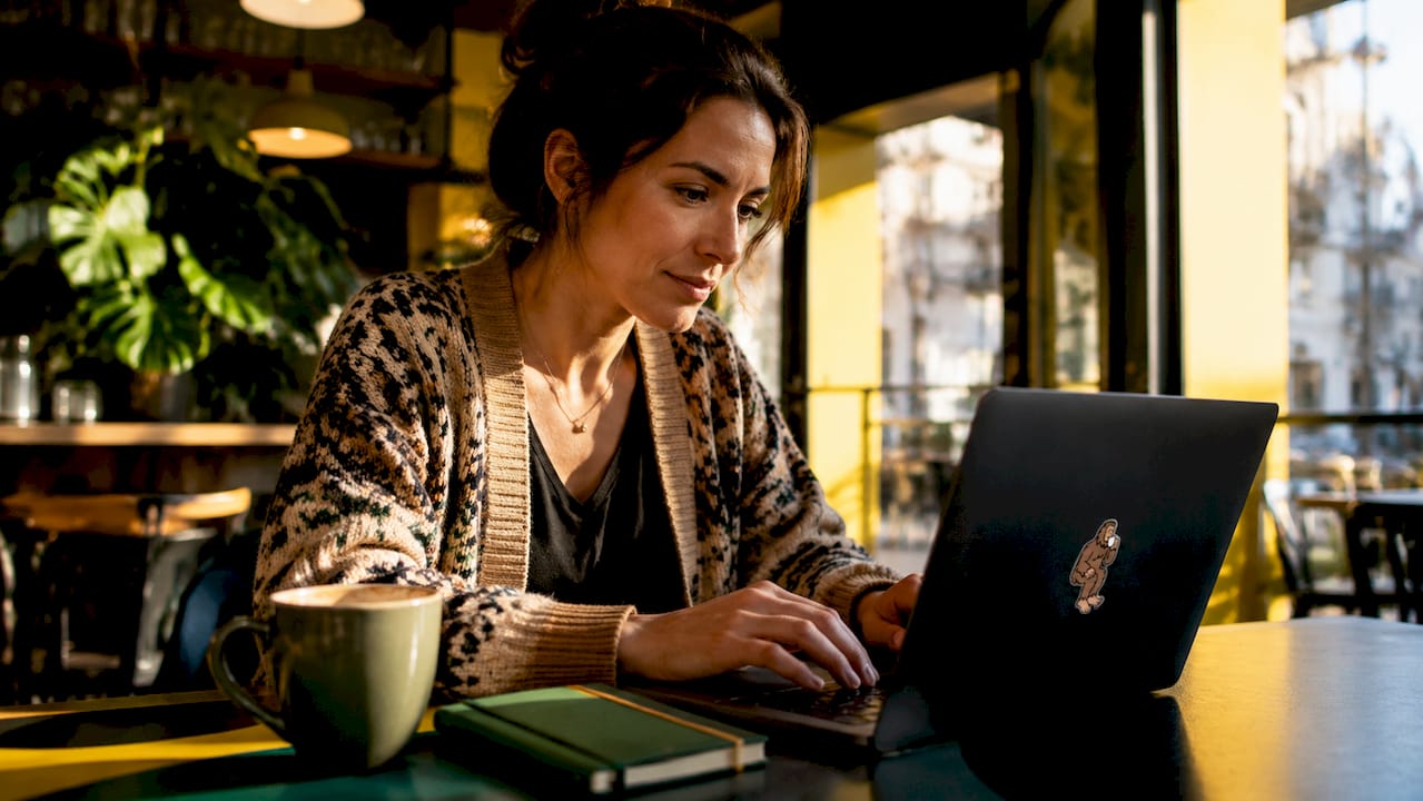 Person browsing flexible coffee subscription at home