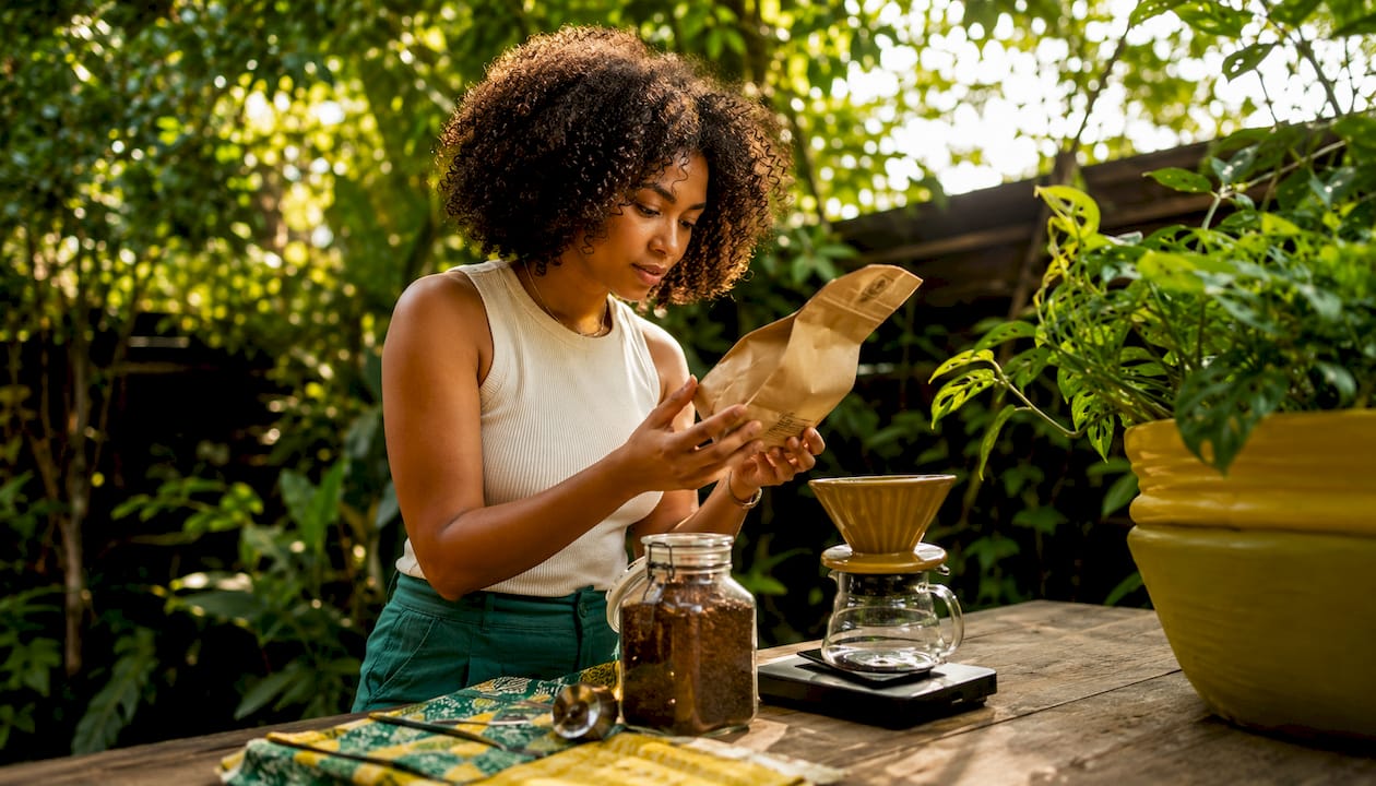 Woman checking roast date on coffee bag