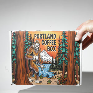 A hand holding Portland Coffee Box.